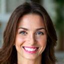 Portrait of Sarah M., smiling woman in her 40s.